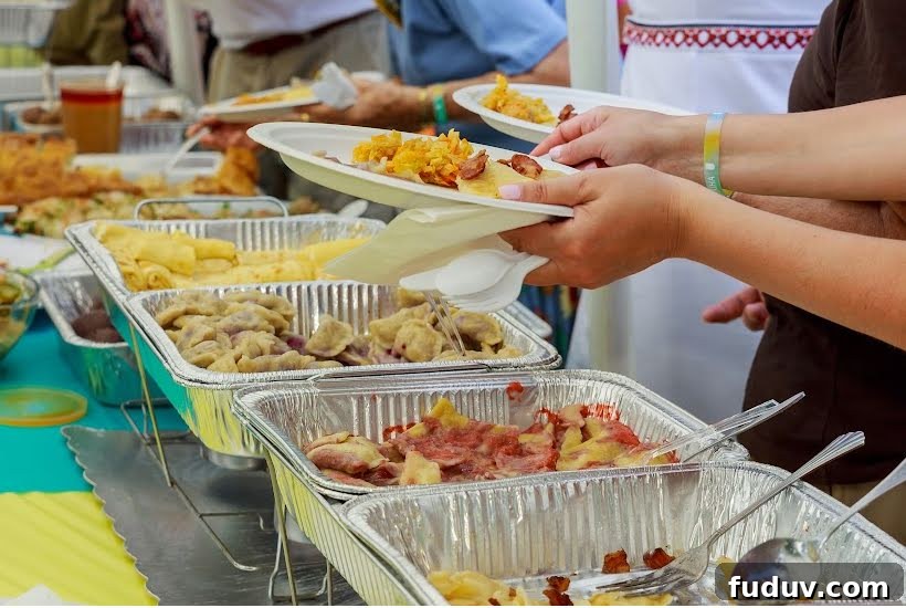 Taco Party Menu Ideas for a Crowd: Recipes, Sides & Drinks 5 Foil chafing dishes filled with taco fillings and side dishes.