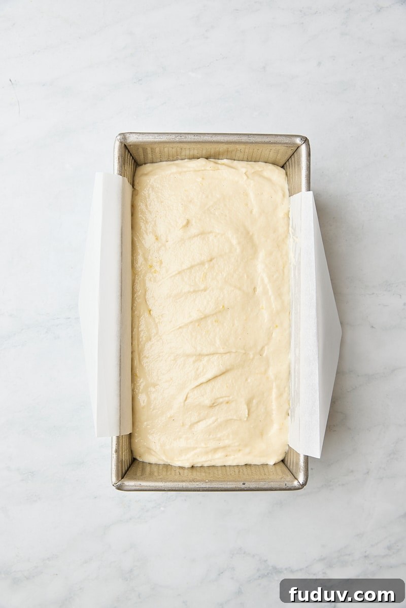 Cake batter in parchment-lined loaf pan