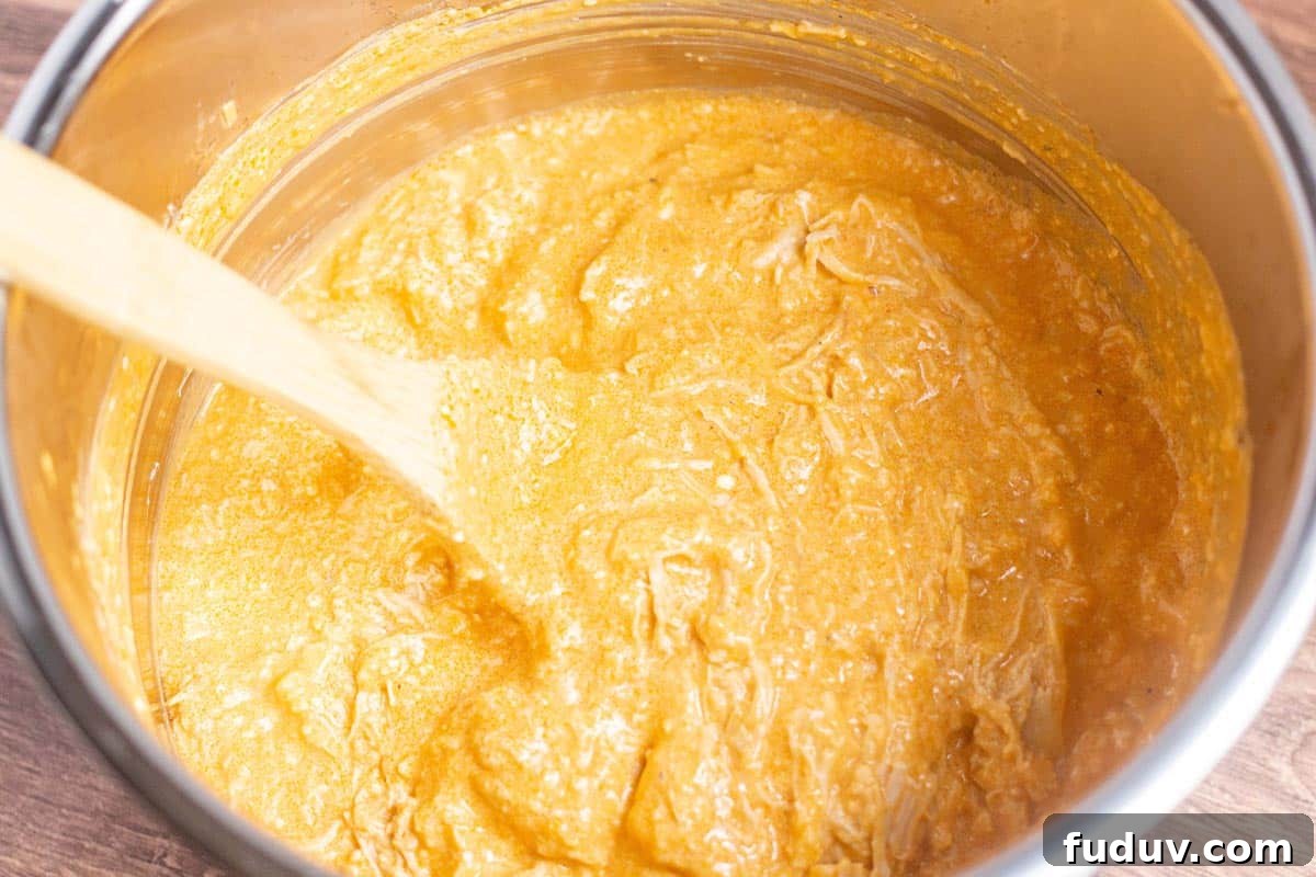 Shredded chicken mixed into cheesy buffalo dip in the Instant Pot.