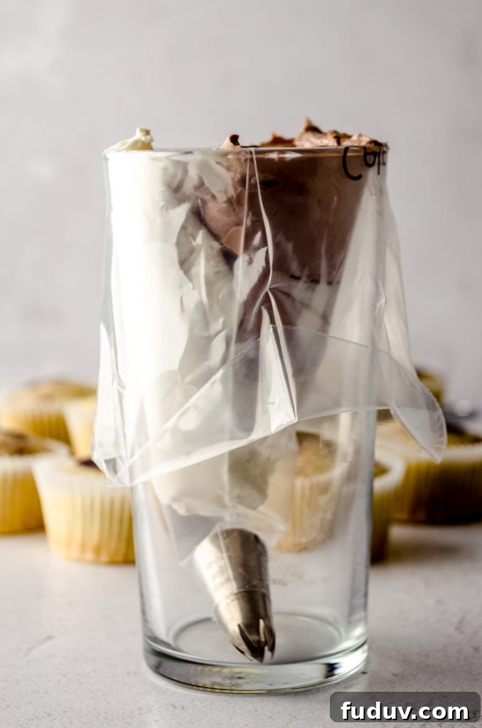 Piping bag with white and brown frosting side-by-side