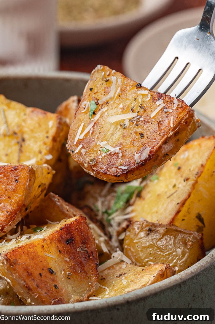 Crispy roasted mini potatoes with fluffy centers and golden edges. The perfect easy side dish for any dinner or holiday table. #roastedpotatoes #potatosidedishes crispy roasted mini potatoes on a fork