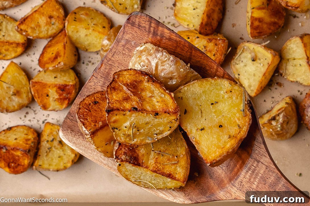Crispy Roasted Mini Potatoes with Garlic and Herbs 2 crispy roasted mini potatoes on a sheet pan