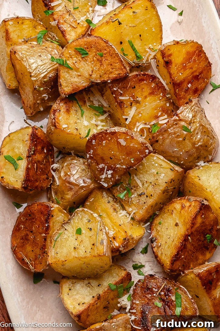 Crispy Roasted Mini Potatoes with Garlic and Herbs 3 crispy roasted mini potatoes on a sheet pan