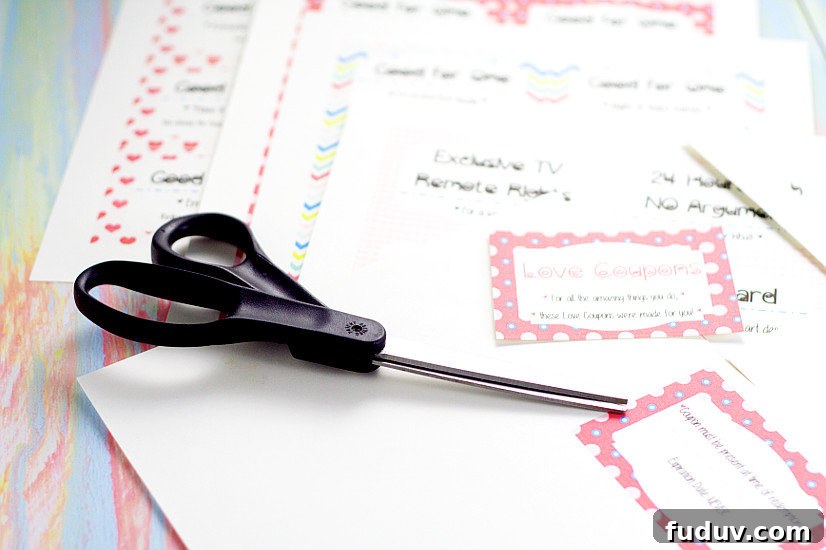 Black scissors on top of printed love coupon book