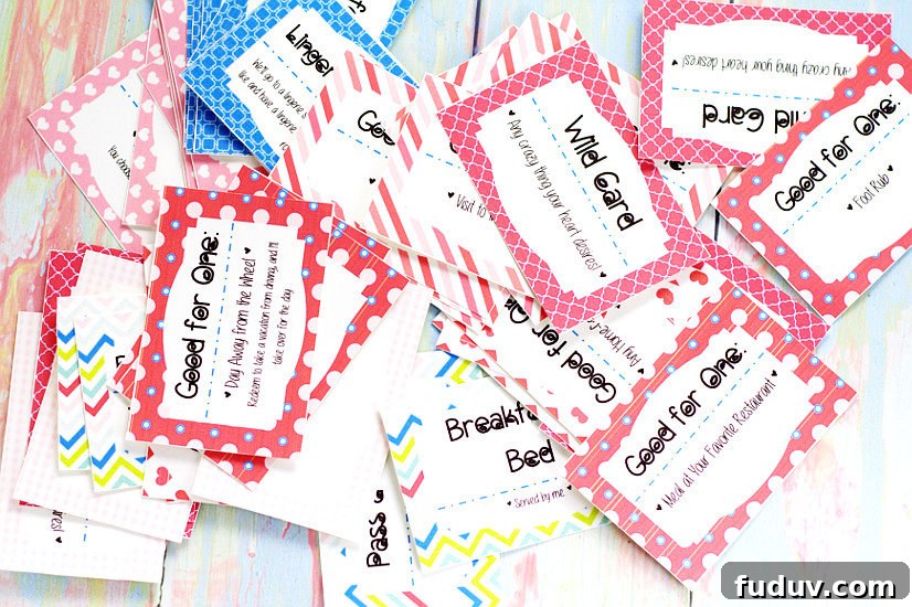 Cut out love coupons in a pile on a pastel rainbow wood background