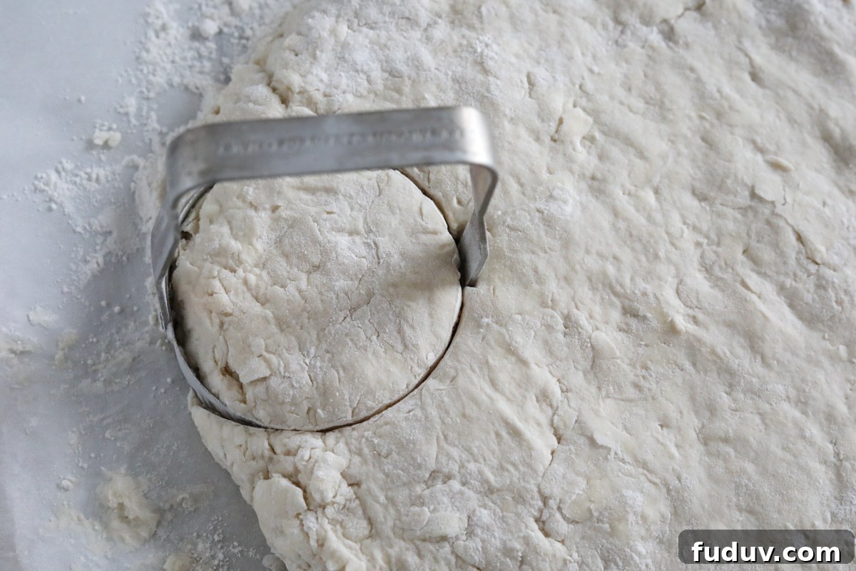 the biscuit dough rolled out and being cut