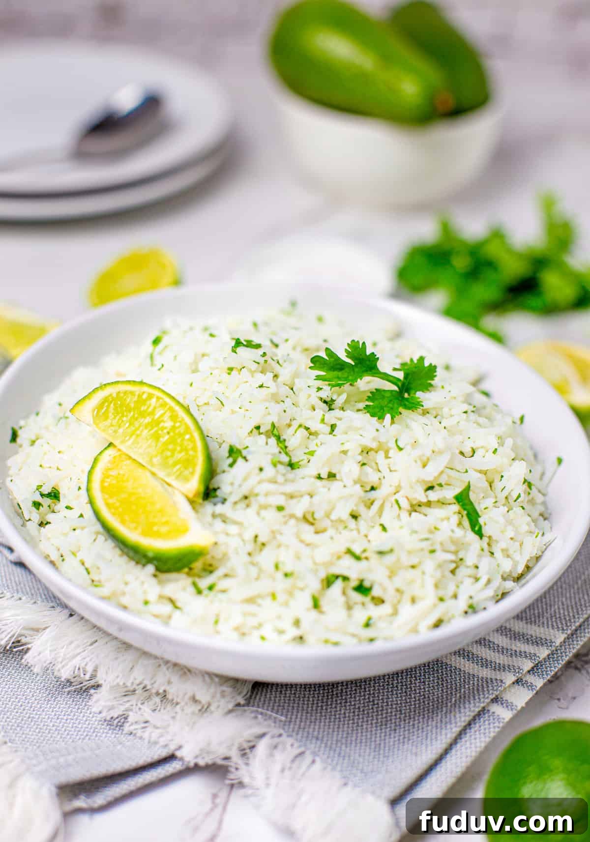 Cilantro Lime Rice Recipe: Flavorful Side Dish in 20 Minutes 2 White bowl of Lime Rice in bowl with limes and cilantro