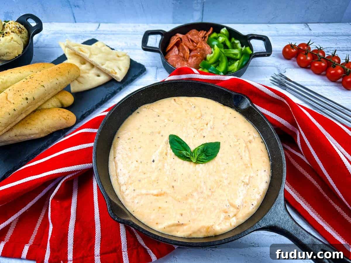 A skillet filled with pizza fondue and bread on a table.