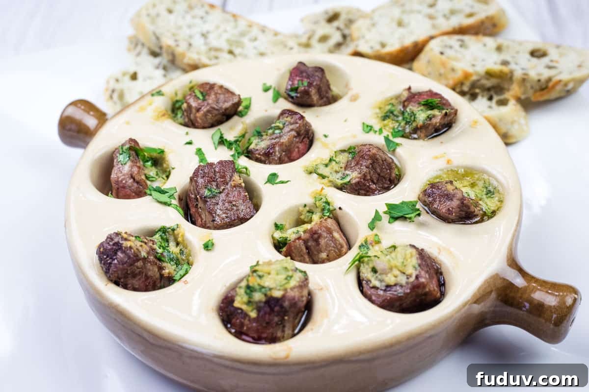 Escargot-style Garlic Butter Steak Bites in a round dish.