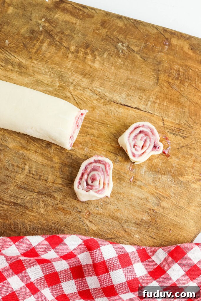 Cutting rolled pie dough on wooden board.