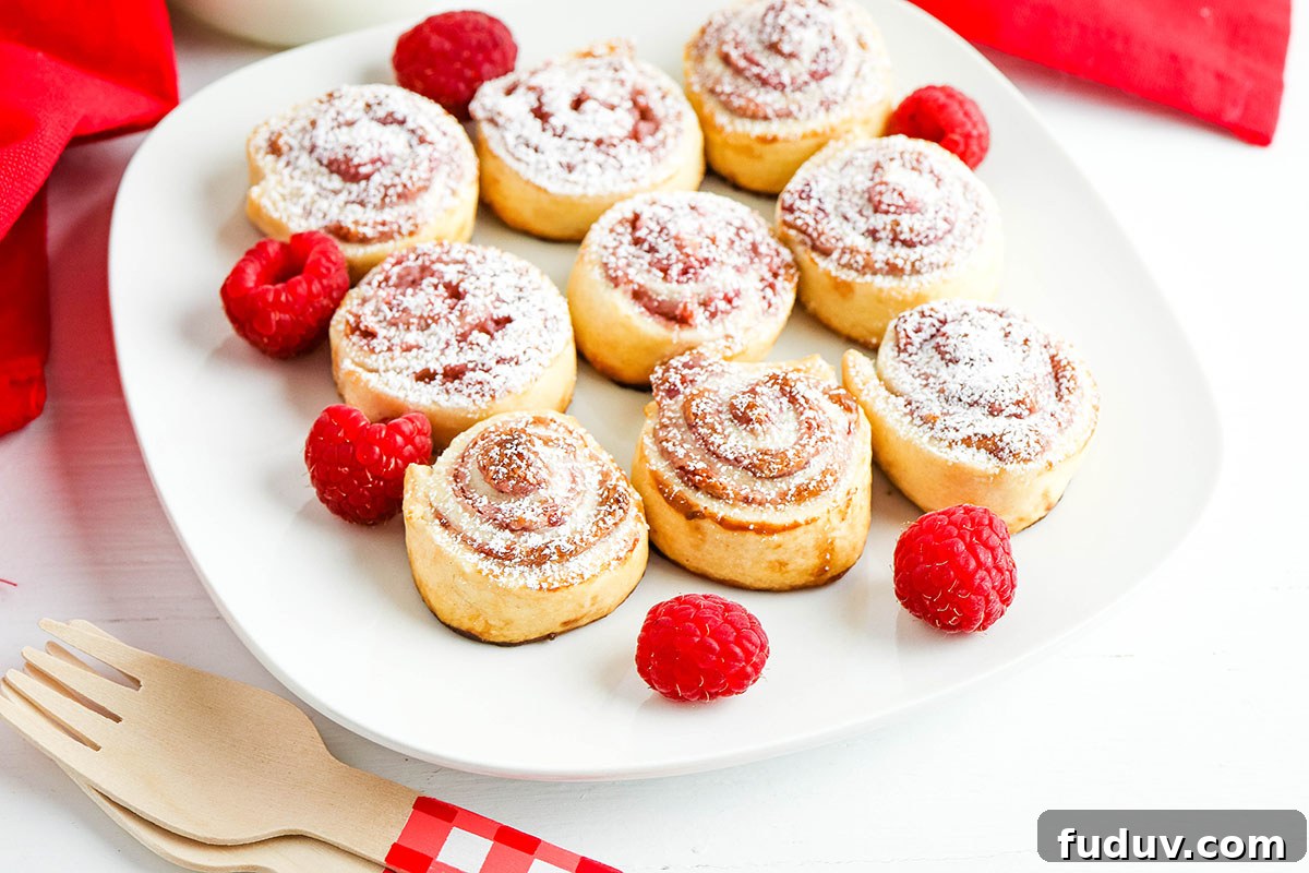 Nine Raspberry Cream Cheese Pinwheels on square white serving plate.