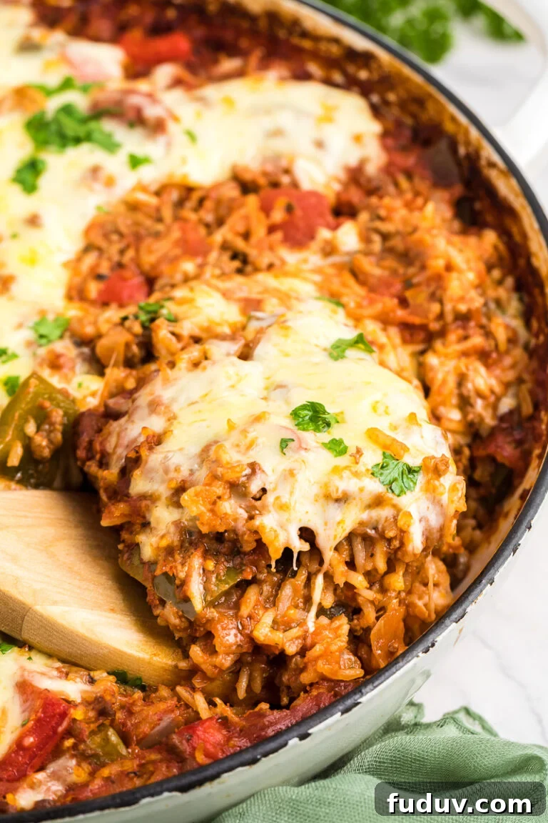 Stuffed pepper casserole scooped from baking dish onto a spoon.