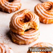 How to Make Classic French Crullers at Home 10 a side close up at a stack of two crullers with the top one missing a bite