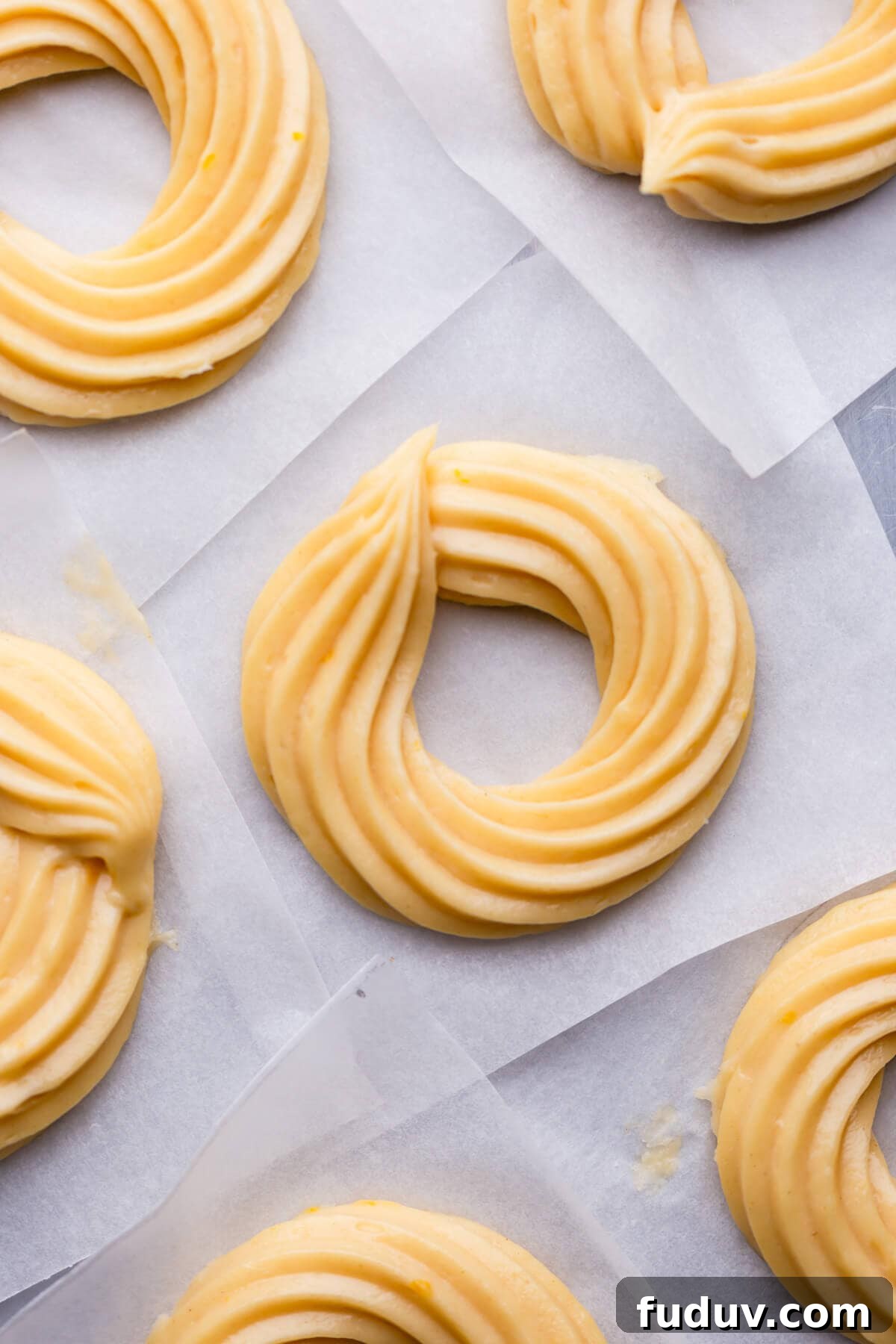 How to Make Classic French Crullers at Home 4 overhead view of raw french cruller doughnuts on parchment paper