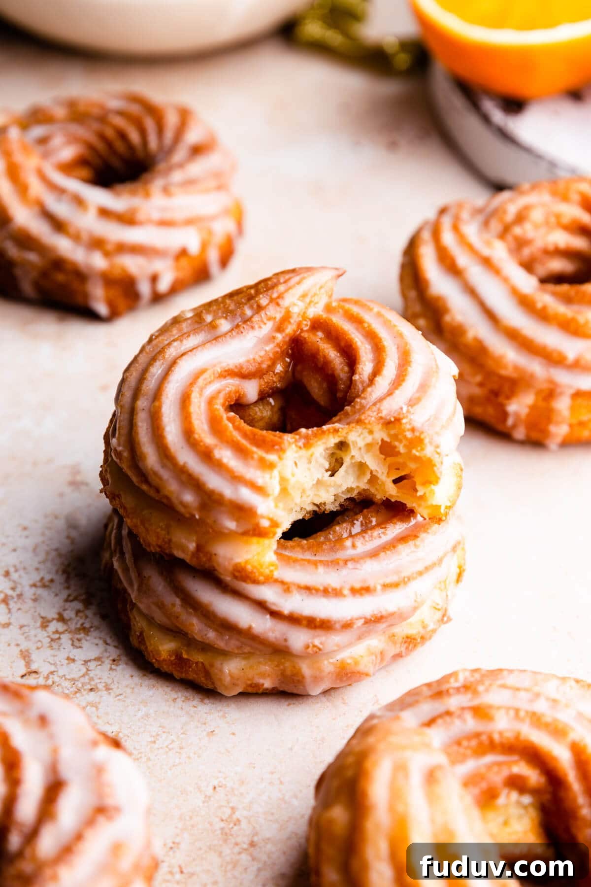 How to Make Classic French Crullers at Home 8 a side close up at a stack of two crullers with the top one missing a bite