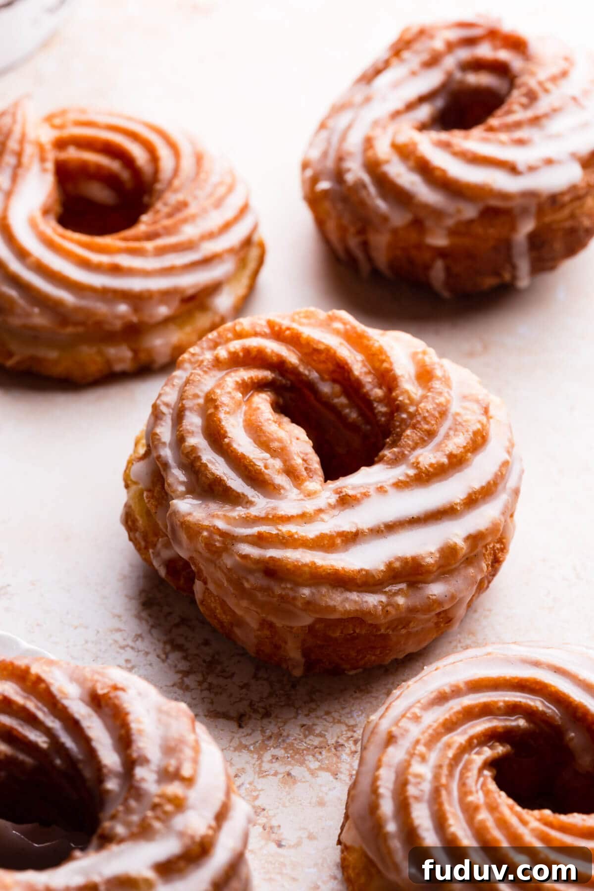 How to Make Classic French Crullers at Home 9 45 degree angle close up view at choux pastry doughnuts dipped in glaze