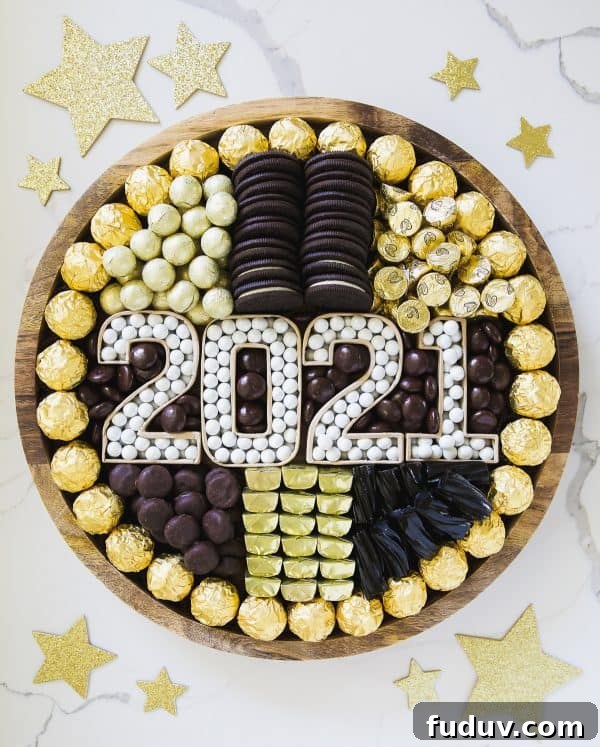A pumpkin and a princess created a gold and black board with Oreos, gold candies, and more.