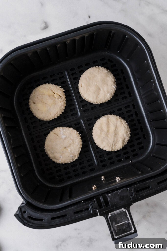 Crispy Air Fryer Biscuits: Quick Flaky Homemade Recipe 11 biscuits on the air fryer basket.