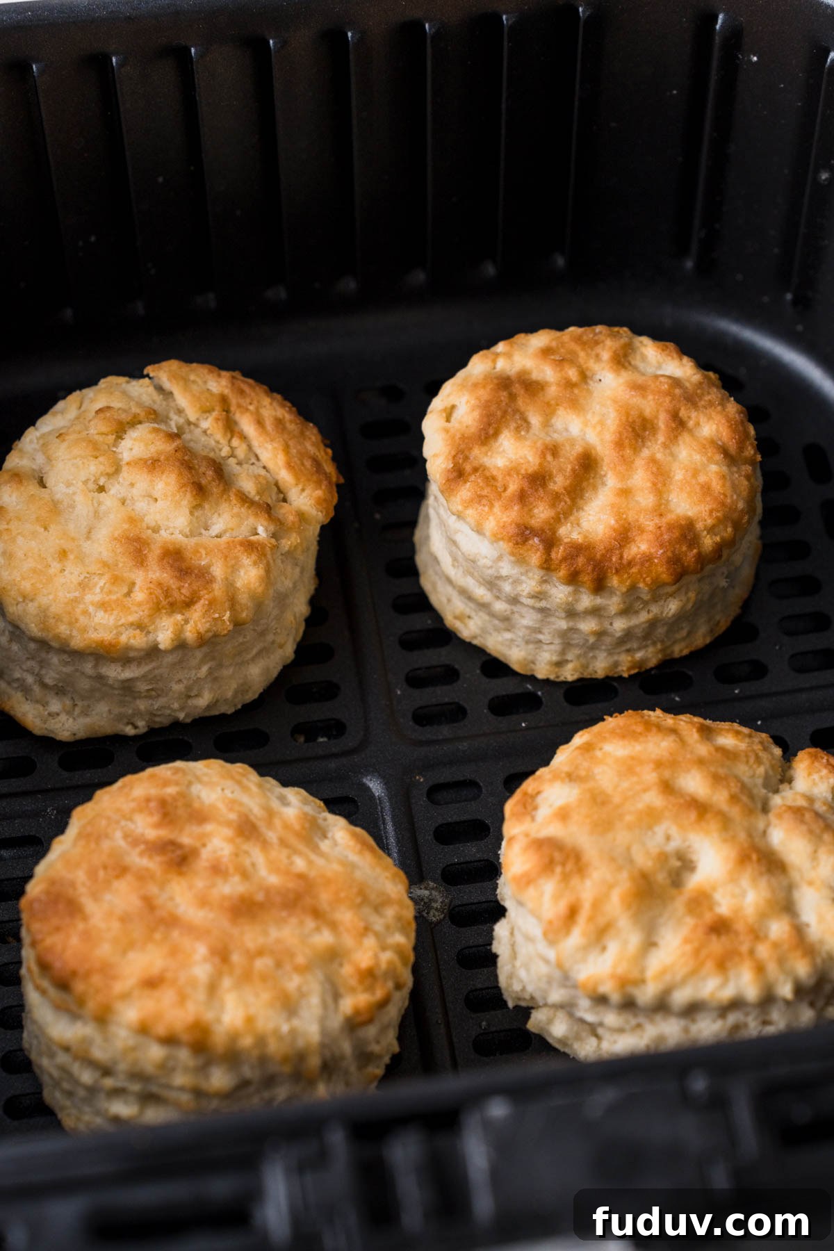 Crispy Air Fryer Biscuits: Quick Flaky Homemade Recipe 12 air fryer biscuits in the air fryer basket.