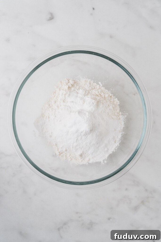 Crispy Air Fryer Biscuits: Quick Flaky Homemade Recipe 4 all purpose flour in a bowl on a white background.