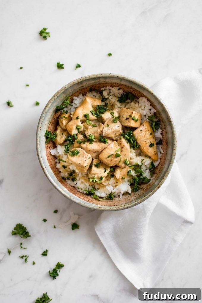 bowl of Instant Pot honey garlic chicken in a bowl with white cloth napkin beside it