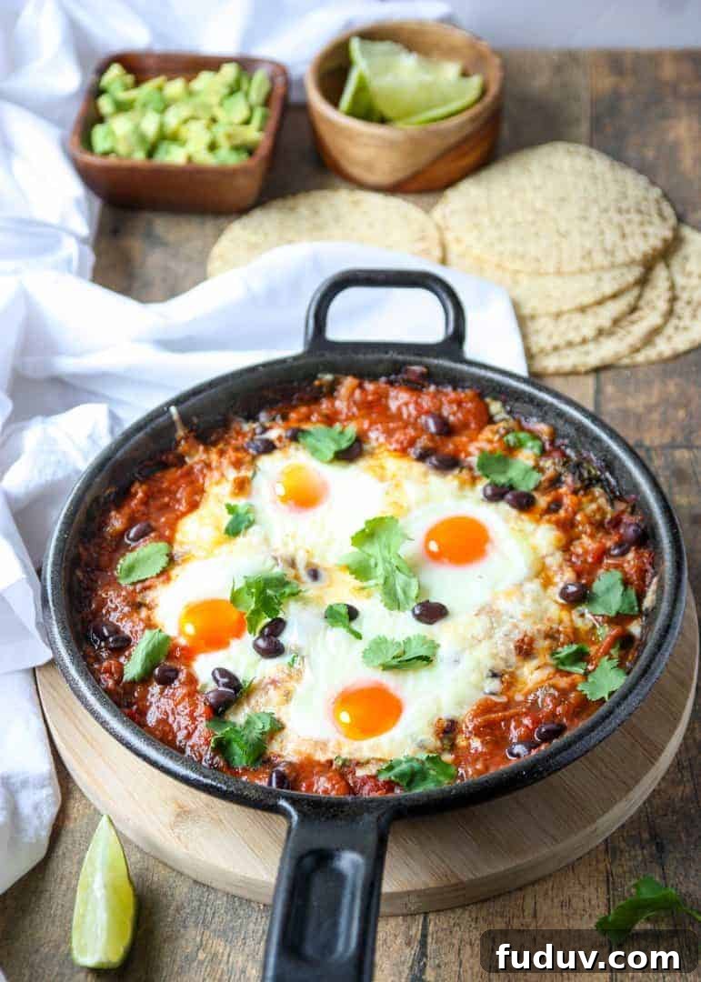 Baked Huevos Rancheros Recipe: Flavorful Rancher’s Eggs Casserole 4 Top shot of a black skillet filled with baked huevos rancheros.