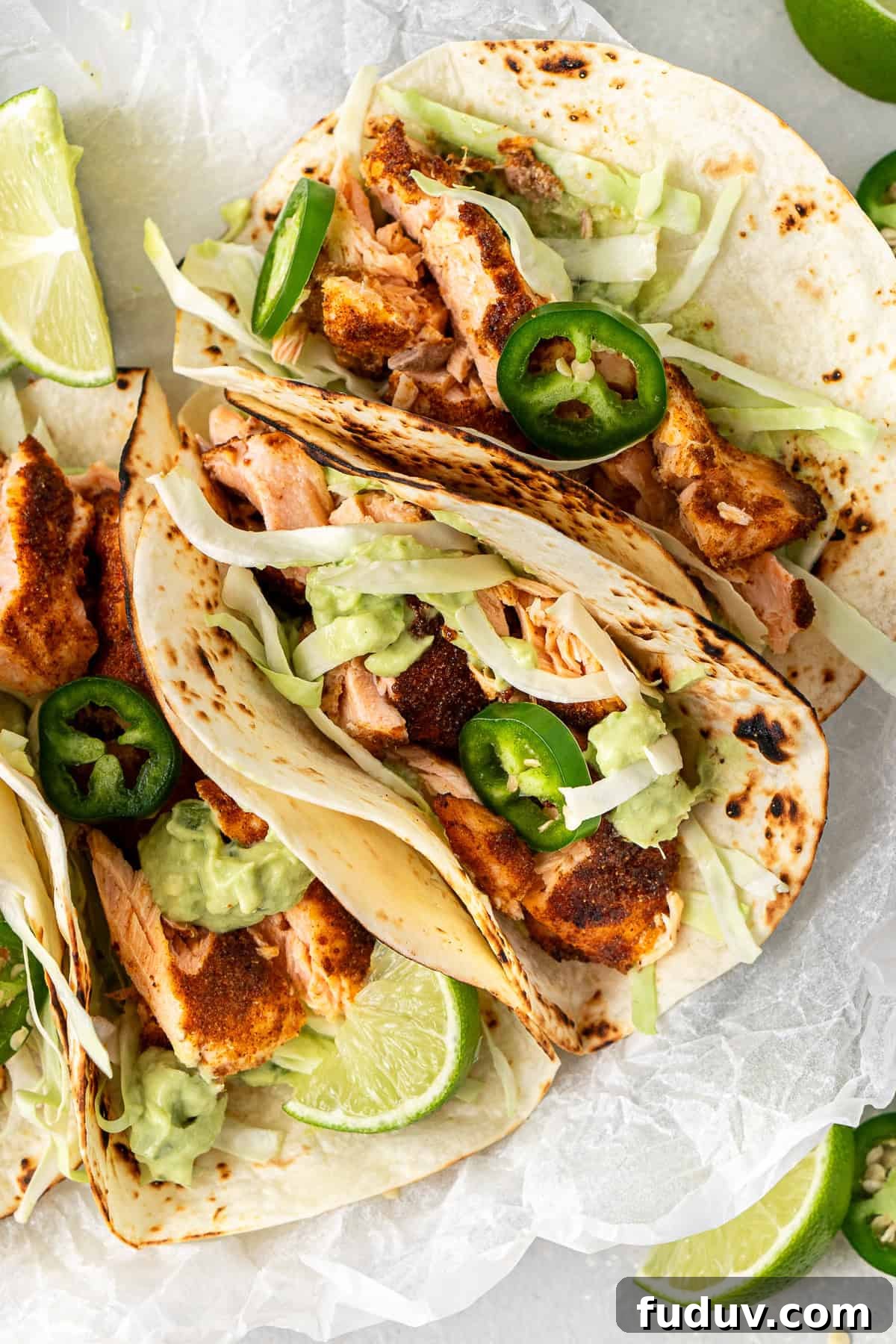 Grilled Salmon Tacos with Creamy Avocado Lime Crema 4 Close up of the salmon tacos with shredded cabbage, jalapenos and avocado crema.
