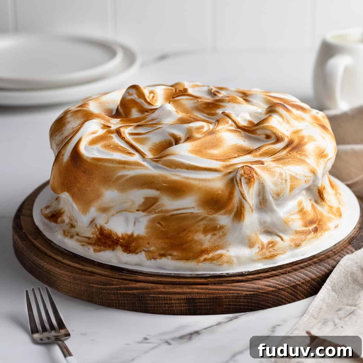 Cipriani vanilla meringue cake on a cake stand 