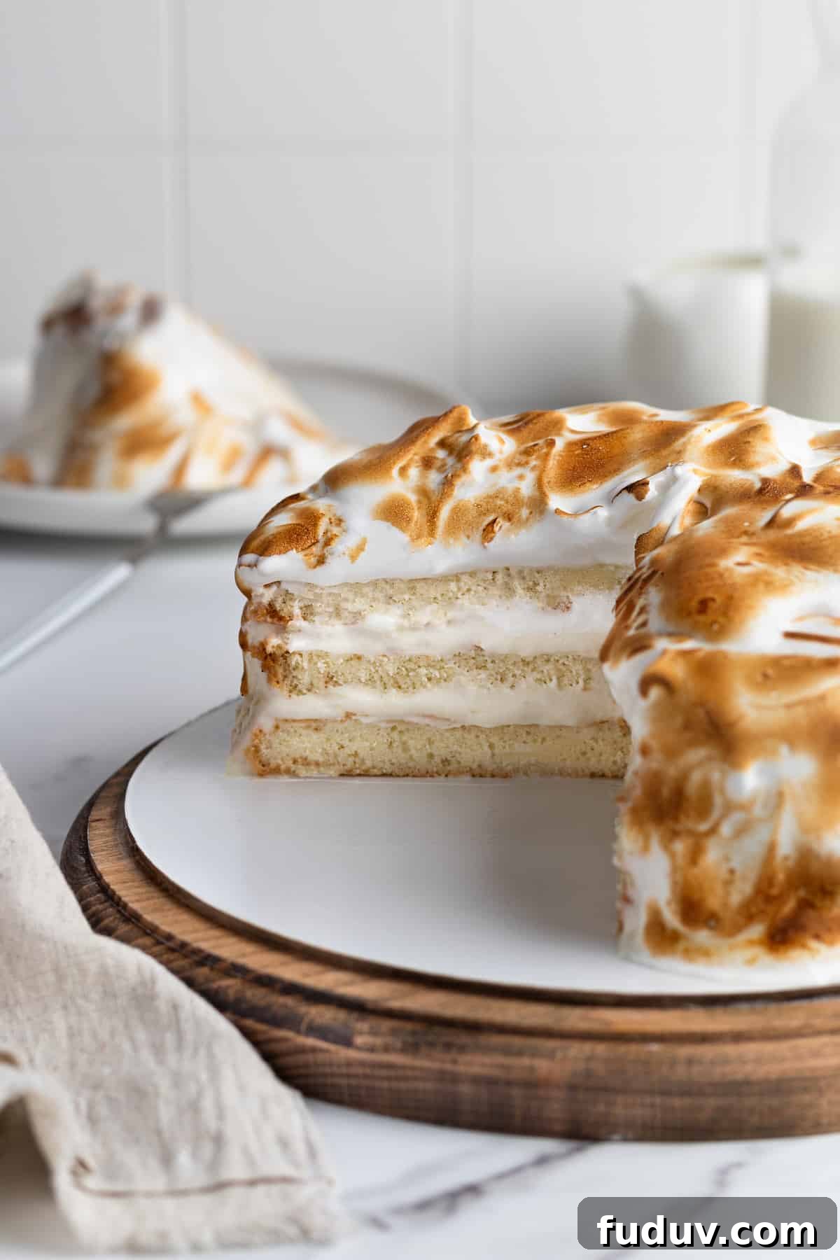 Sliced Cipriani meringue cake on a cake stand
