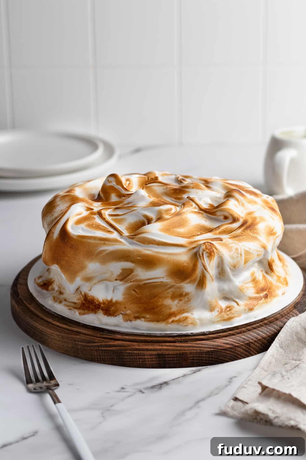 Toasted meringue cake on a cake stand