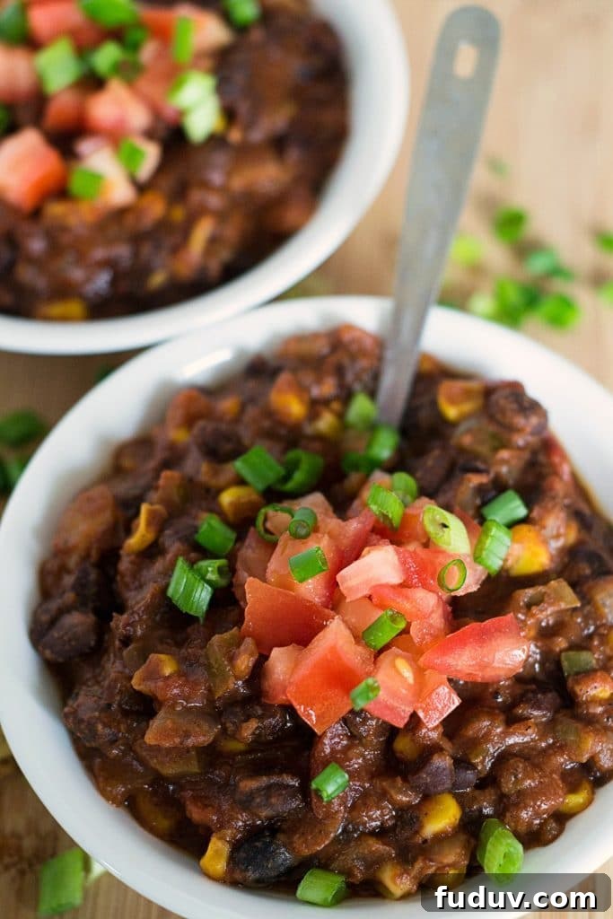 vegan black bean and corn chili in white bowls