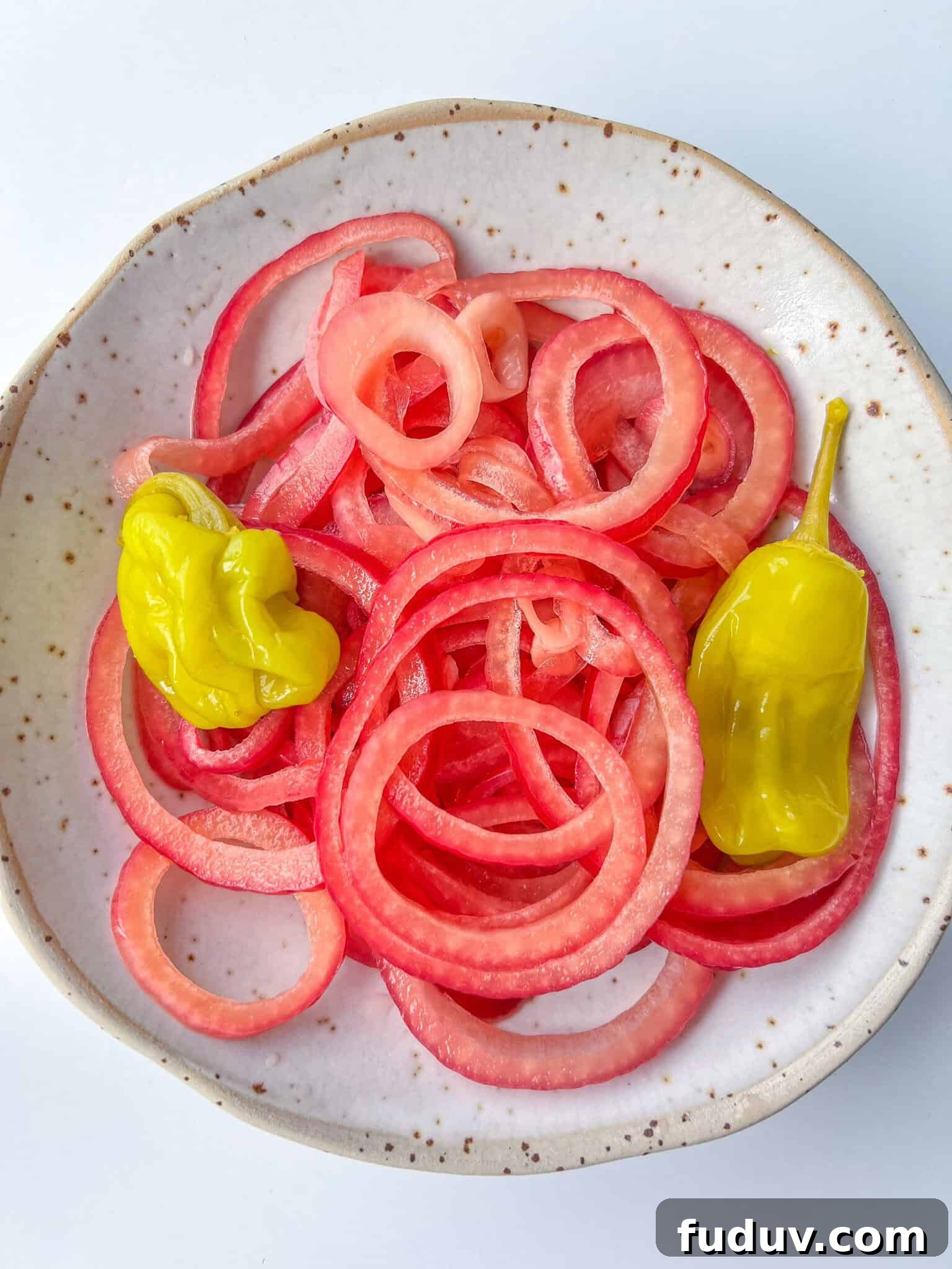 Bowl of homemade pickled red onions with pepperoncini