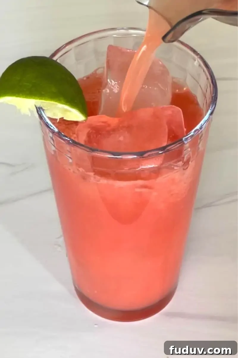Watermelon Water in a glass with a lime wedge. 