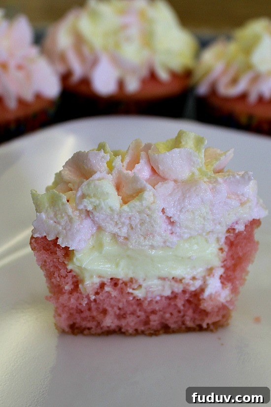 Inside half of a lemon filled strawberry cupcake.