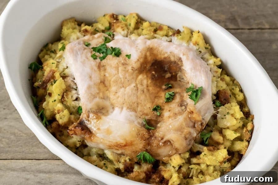Baked Pork Chops and Stuffing in a casserole dish.