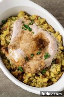 Baked Pork Chops and Stuffing in an individual white baking dish.