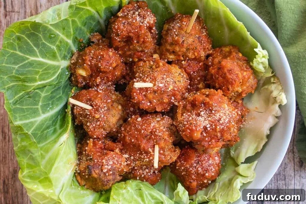baked Italian meatballs in a bowl lined with cabbage leaf