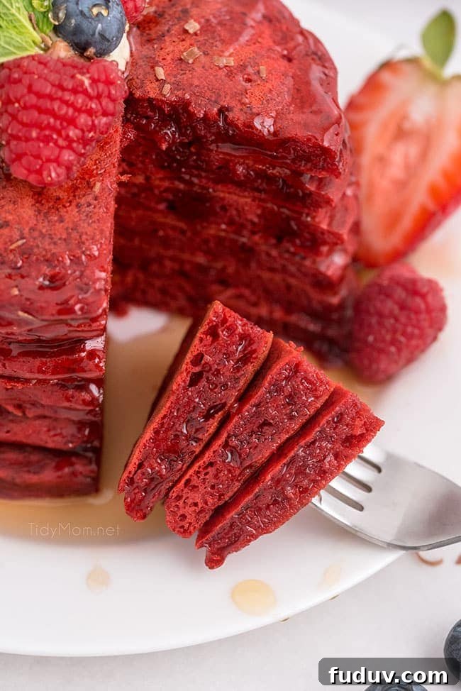 Red Velvet Pancakes Recipe with Video Tutorial 9 red velvet pancakes with the first bite on a fork