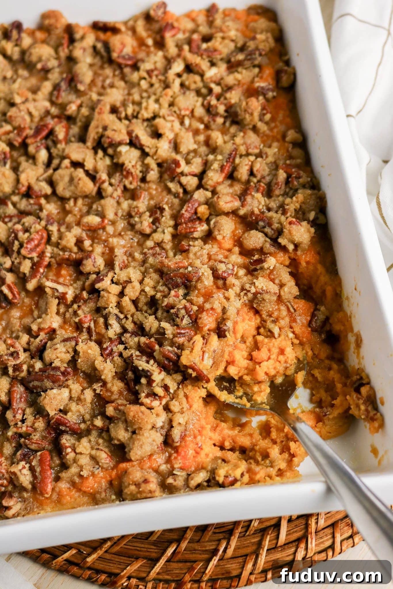 Sweet Potato Casserole Made with Canned Yams — Quick Holiday Side 12 Close up of sweet potato casserole showing creamy filling and crunchy pecan topping - Hostess At Heart