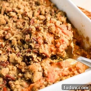 Sweet Potato Casserole Made with Canned Yams — Quick Holiday Side 13 Serving spoon scooping a portion of sweet potato casserole with pecan topping - Hostess At Heart