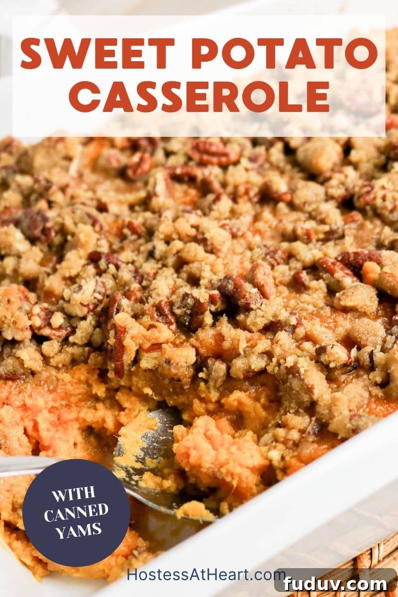 Sweet Potato Casserole Made with Canned Yams — Quick Holiday Side 14 Image for Pinterest of an Easy sweet potato casserole with golden brown pecan topping in a white baking dish - Hostess At Heart