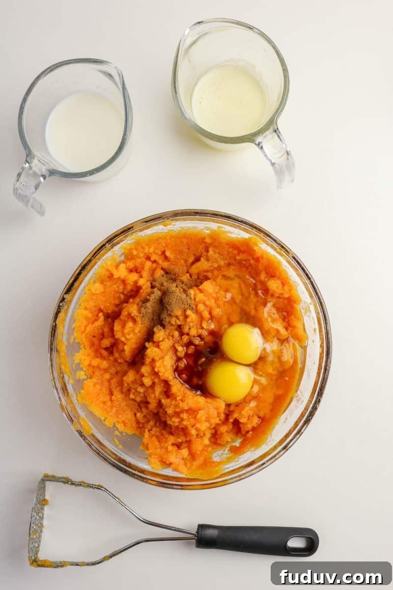 Sweet Potato Casserole Made with Canned Yams — Quick Holiday Side 5 Creamy sweet potato casserole filling mixed with eggs, butter, and cinnamon in a bowl - Hostess At Heart