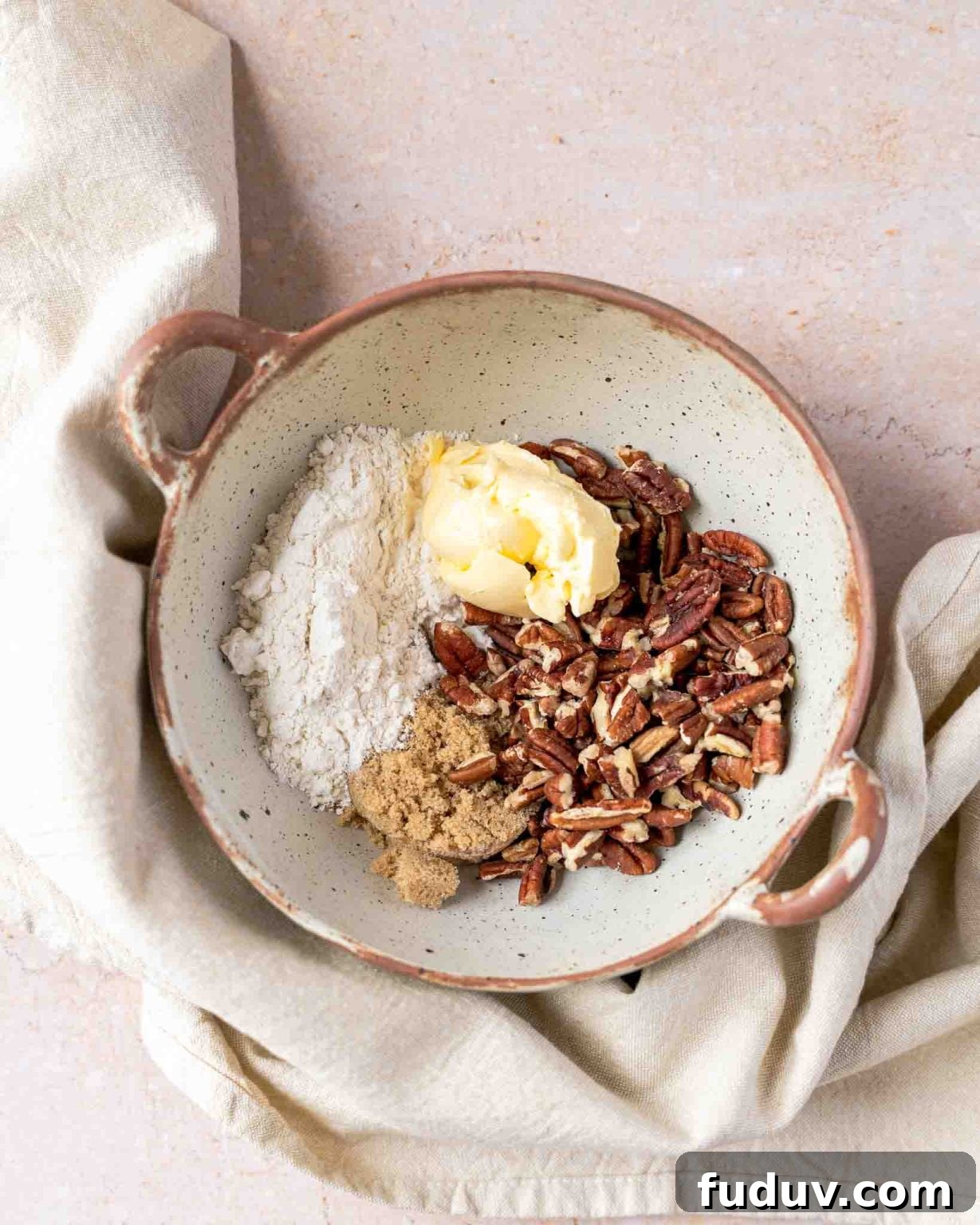 Sweet Potato Casserole Made with Canned Yams — Quick Holiday Side 8 A small bowl filled with pecan topping mixture including butter, brown sugar, pecans, and flour - Hostess At Heart