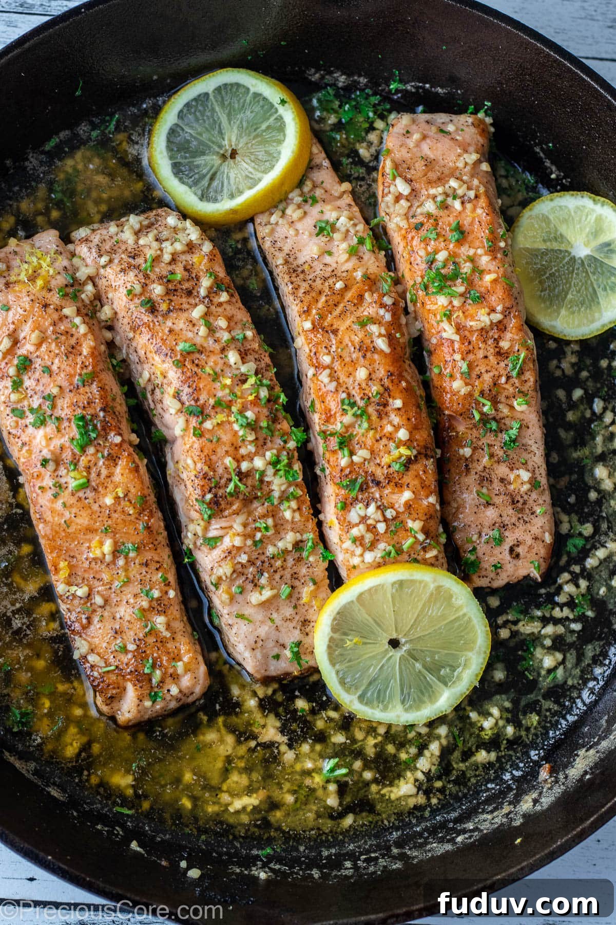 4 pieces of salmon in a cast iron skillet.