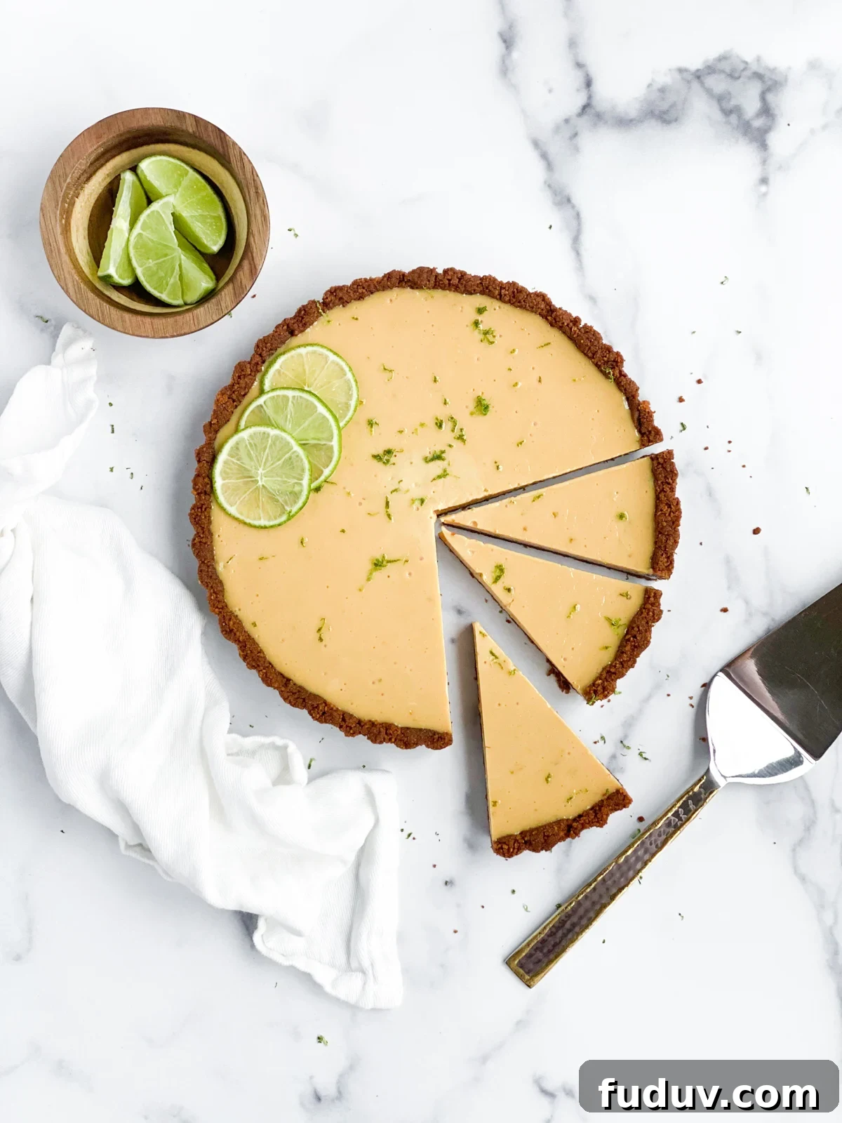 key lime pie with 3 slices cut