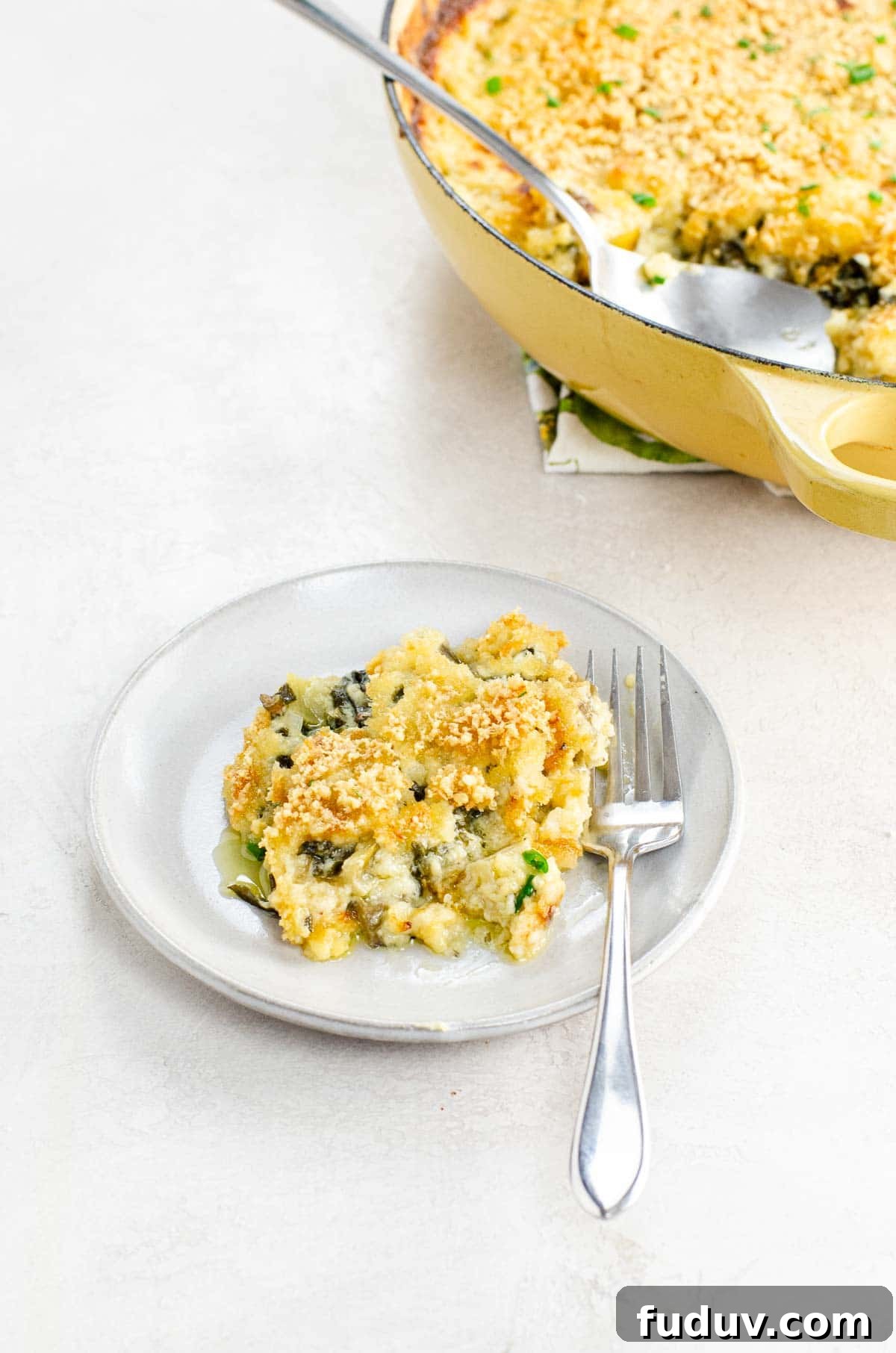 Swiss Chard Gratin Recipe from The Herbfarm Restaurant 2 swiss chard gratin on a small plate with a fork