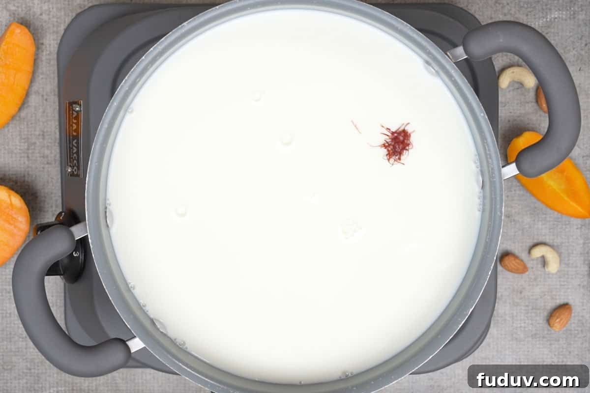 Creamy Mango Basundi Recipe: Authentic Indian Dessert Guide 4 Saffron and milk added to the pan.