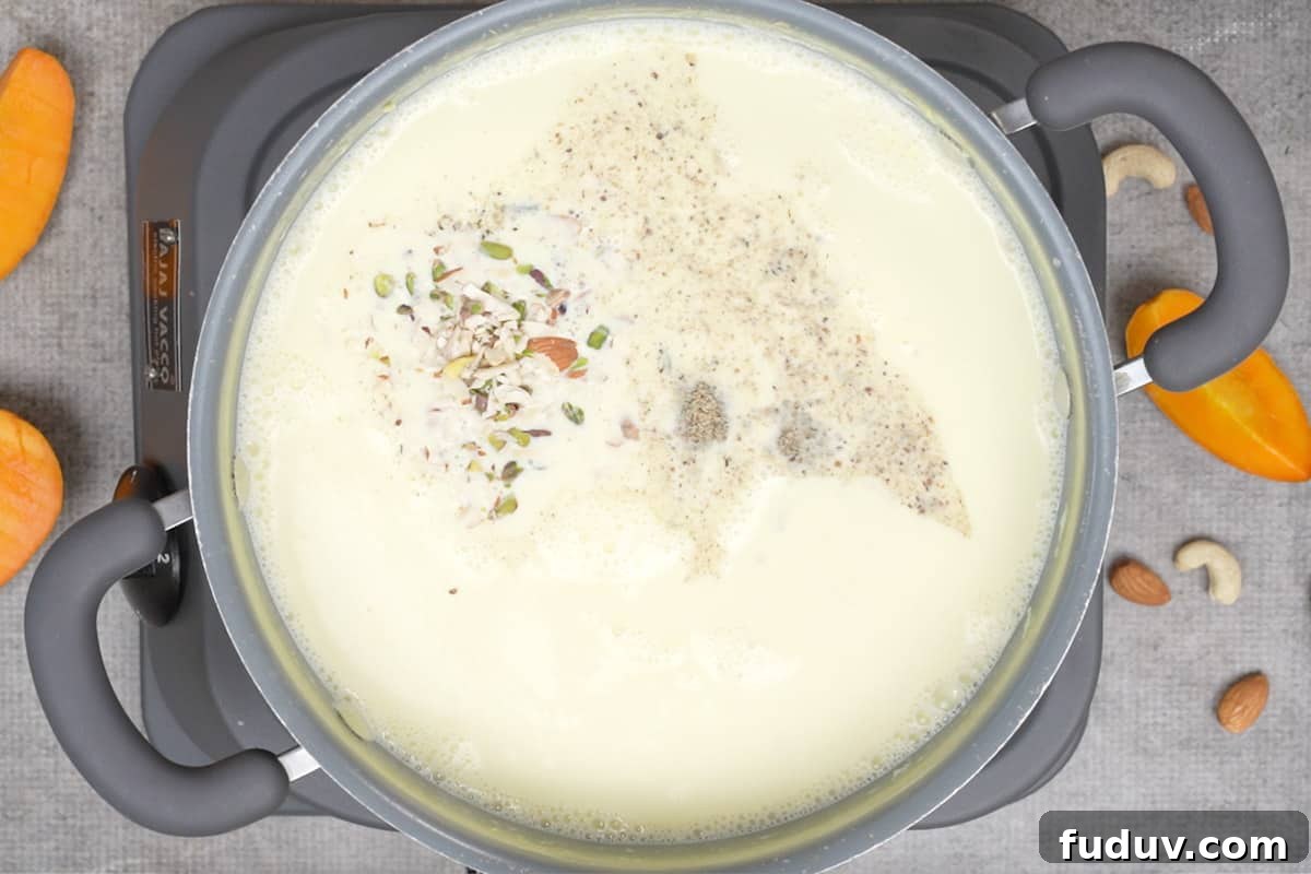 Creamy Mango Basundi Recipe: Authentic Indian Dessert Guide 6 Sugar, cardamom and nuts added to the pan.