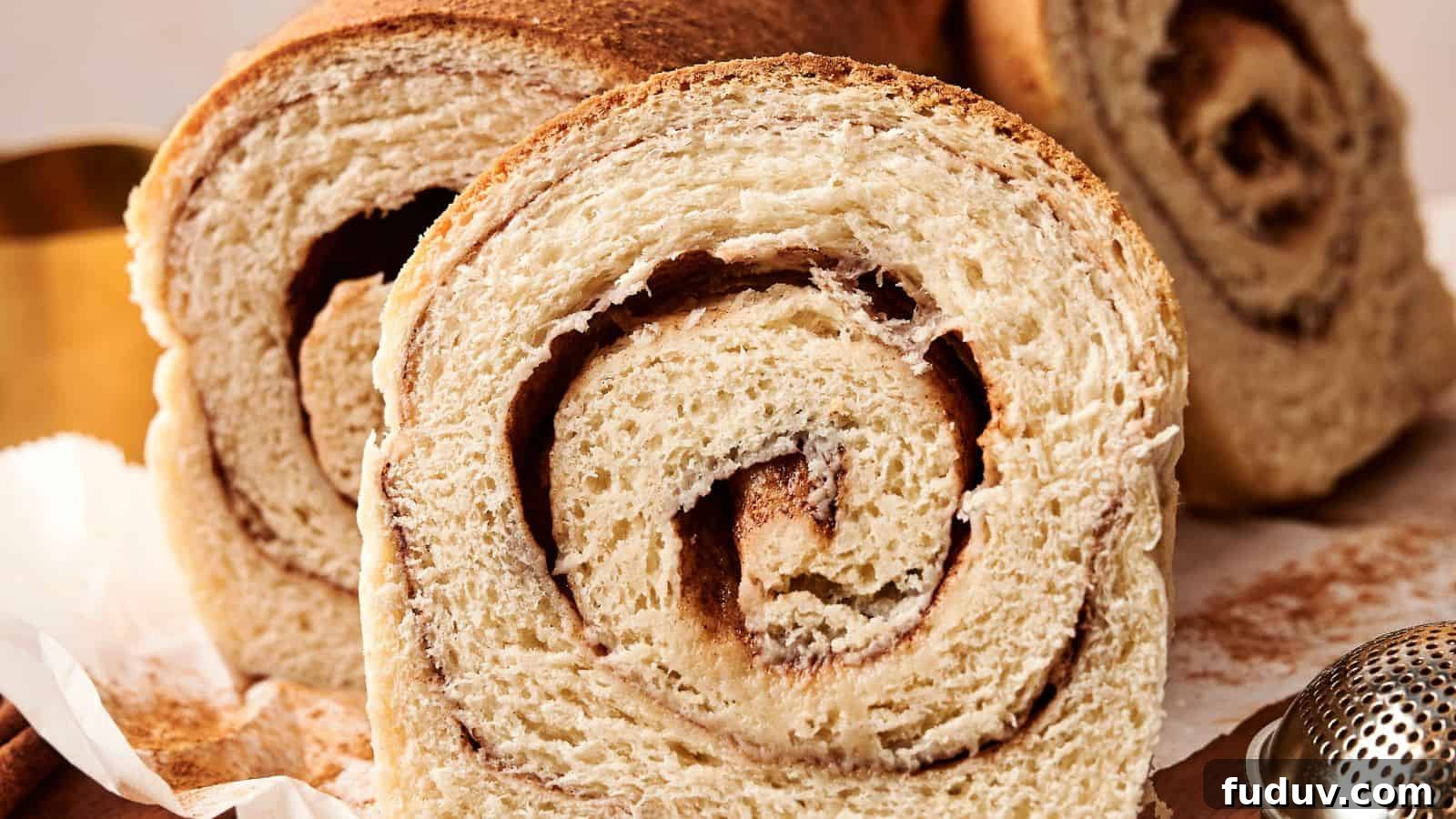 31 Cozy Cinnamon Recipes to Warm Your Home and Soul 2 Close-up of cinnamon swirl bread slices, showcasing a spiral pattern in the texture.