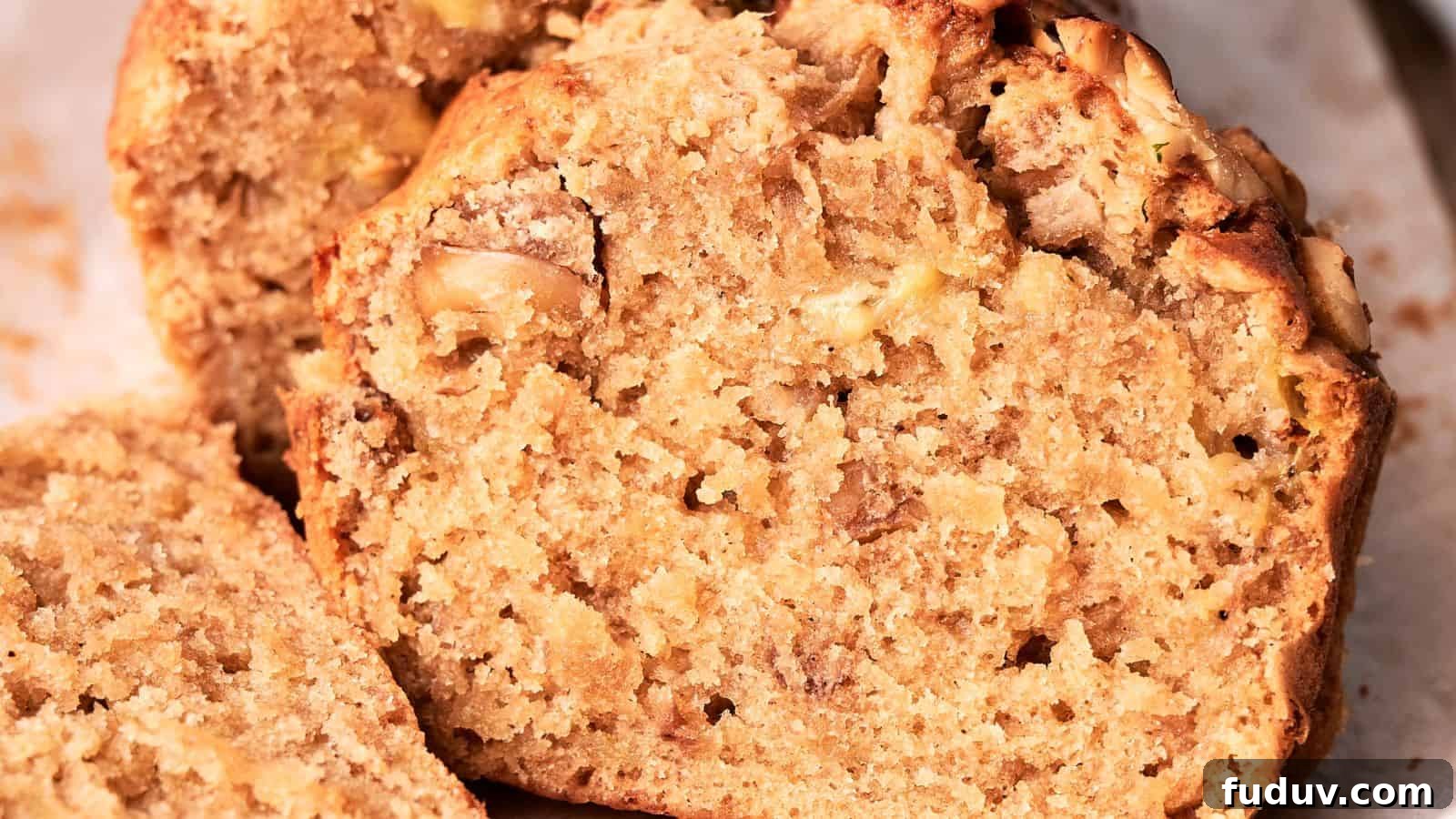 31 Cozy Cinnamon Recipes to Warm Your Home and Soul 13 Close-up of a sliced banana bread loaf, showcasing its moist, textured interior with visible banana chunks.